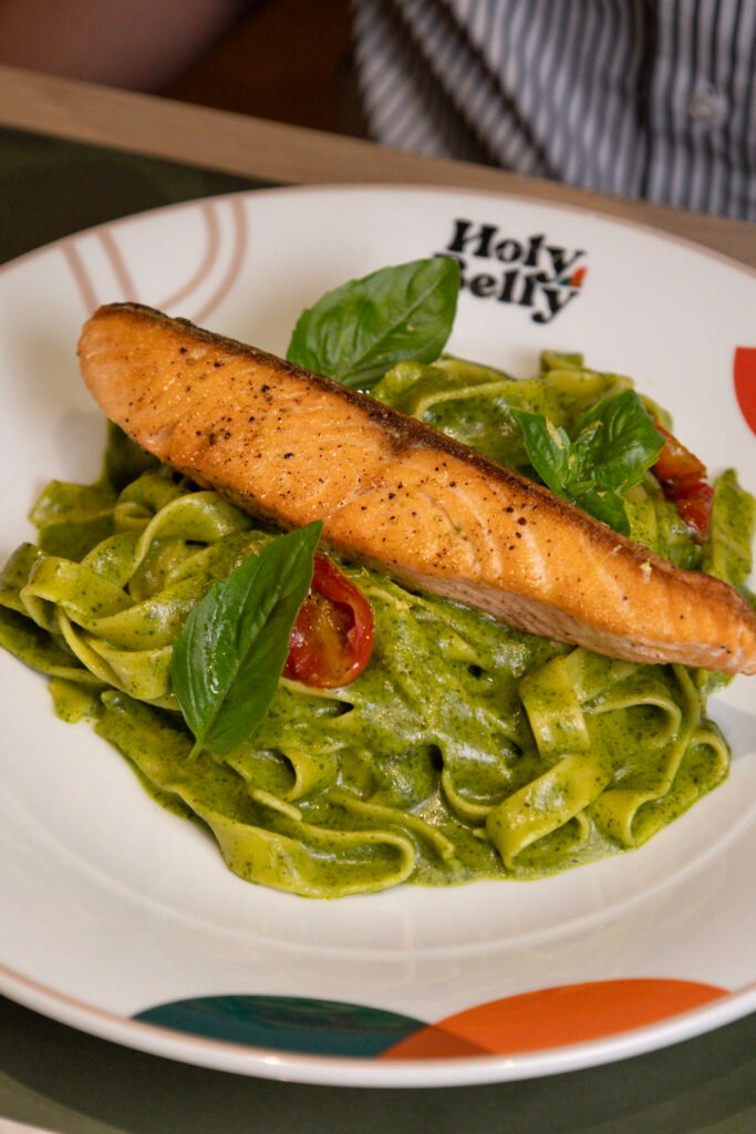 Grilled salmon on handmade pesto tagliatelle at Holy Belly Bangkok